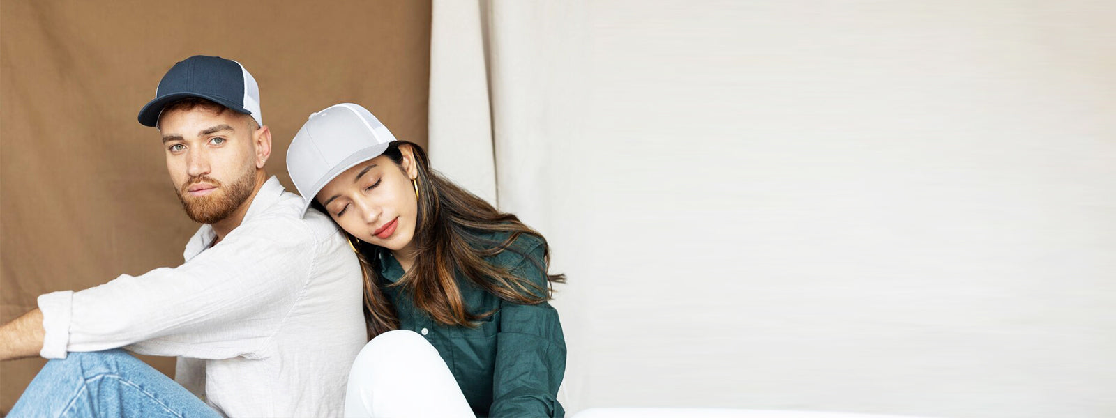 Two models wearing flat bill hats from Blackwater Creek Hat Company